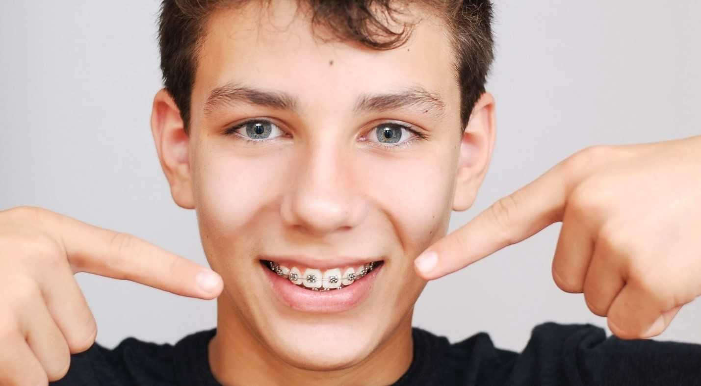 Boy points to braces and wonders, “how long do braces take?”