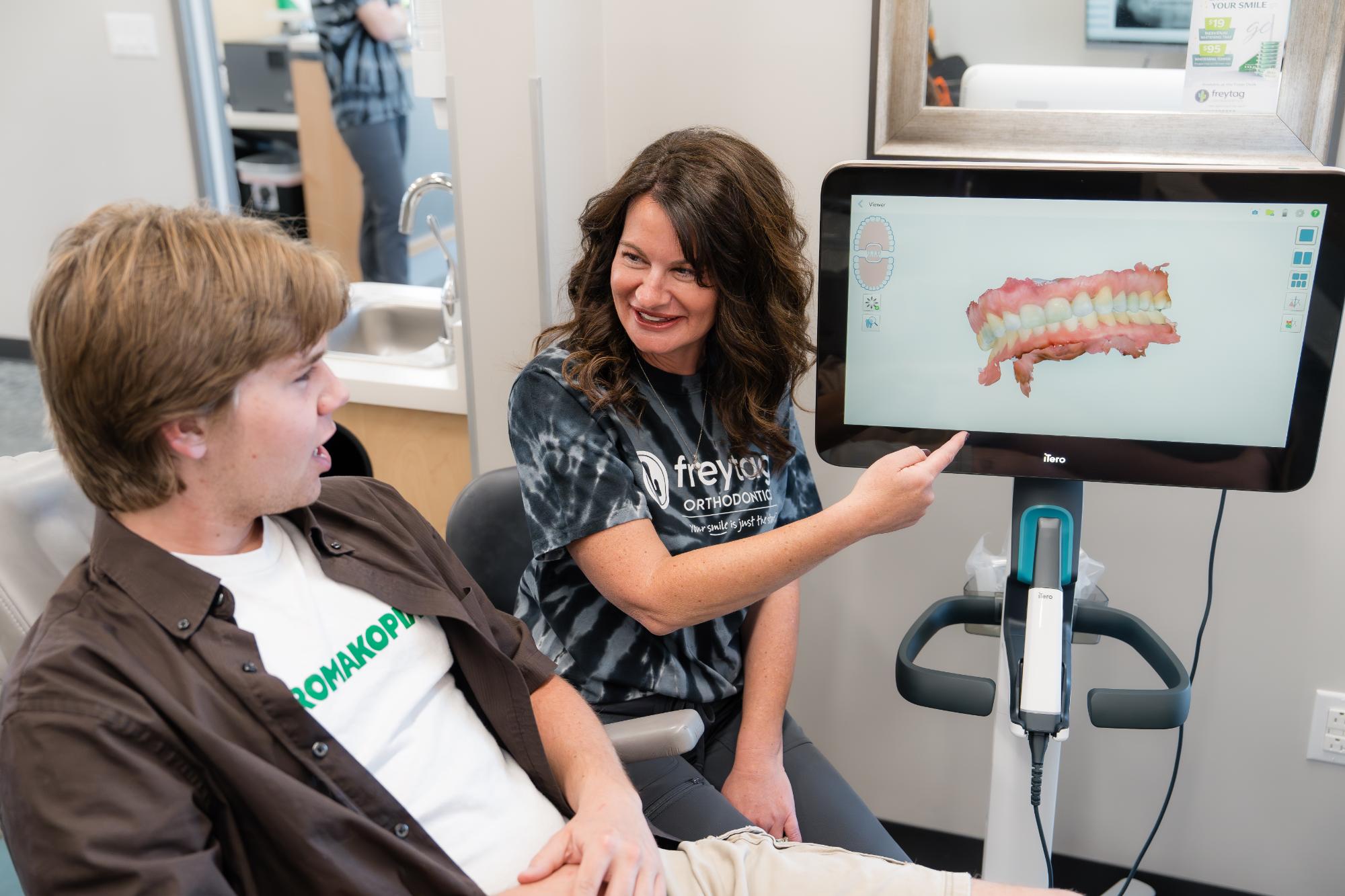 Patient smiling for a painless digital orthodontic scan at Freytag Orthodontics